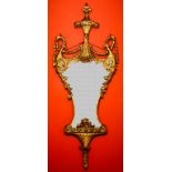 A FINE LATE 18TH OR EARLY 19TH CENTURY CARVED GILT AND GESSO WALL MIRROR, of vase form, with leaf