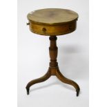 A CIRCULAR 19TH CENTURY EBONY STRUNG OCCASIONAL DRUM TABLE, with three mock and one frieze drawer,