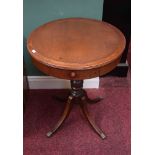 A SMALL REGENCY STYLE MAHOGANY DRUM TABLE, the circular top with one frieze drawer, raised on a