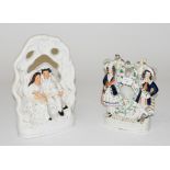 A 19TH CENTURY STAFFORDSHIRE FLATBACK GROUP, modelled as a young man and woman with dog, 14" (