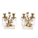 A PAIR OF BRASS CANDELABRA, each with leaf-cast sockets and drip trays, on two leaf-scroll branches,