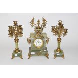 A THREE-PIECE FRENCH GREEN ONYX AND GILT METAL MANTEL CLOCK GARNITURE, the clock case with an urn