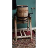 AN OLD OAK METAL-BOUND BARREL-SHAPED BUTTER CHURN, by Wade and Sons, on pine stand, 43" (109cm)