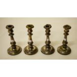 A GOOD SET OF FOUR SILVER PLATED TABLE CANDLESTICKS, each with leaf cast bands, and baluster stem,