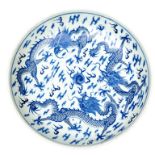 A 19TH CENTURY CIRCULAR CHINESE BLUE AND WHITE DISH, decorated with two dragons, each with four