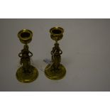 A PAIR OF CAST BRASS MINIATURE CANDLESTICKS,