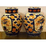 A PAIR OF SMALL JAPANESE IMARI PORCELAIN JARS AND COVERS