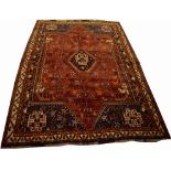 A BURGUNDY GROUND QASHQAI TRIBAL RUG,