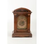 A WALNUT-CASED CHIMING BRACKET CLOCK