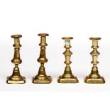 A SET OF FOUR 19TH CENTURY BRASS CANDLESTICKS