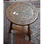 A CARVED OAK TWO TIER LOW OCCASIONAL TABLE