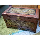 A CARVED AND LACQUERED ORIENTAL LIFT TOP CHEST