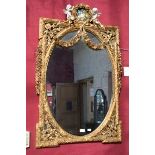 A MODERN COMPOSITION GILT WALL MIRROR