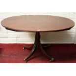 A REGENCY PERIOD EBONY STRUNG OVAL FLIP TOP TABLE