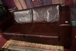 A LARGE THREE SEATER CLUB SETTEE