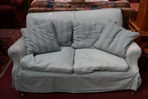 A MODERN TWO SEATER EASY SETTEE