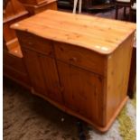 A SERPENTINE FRONTED PINE CUPBOARDS