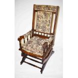 AN EDWARDIAN WALNUT ROCKING CHAIR