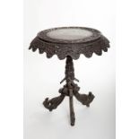 A CIRCULAR BURMESE CARVED DARK WOOD FLIP TOP CENTRE OCCASIONAL TABLE