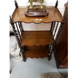 AN EARLY VICTORIAN GRAINED ROSEWOOD AND EBONISED THREE-TIER WHATNOT