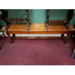 AN OBLONG MAHOGANY BENCH STOOL