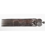 AN AFRICAN CARVED EBONY CEREMONIAL COMB