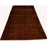 A DARK RED GROUND PERSIAN RUG