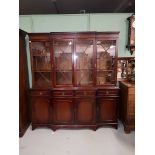 A SMALL GEORGIAN STYLE MAHOGANY BREAKFRONT BOOKCASE