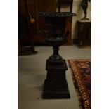 A PAIR OF ATTRACTIVE LOW SIZE CAST IRON CAMPANA-SHAPED GARDEN URNS