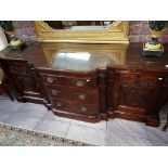 A LARGE CHIPPENDALE STYLE CARVED MAHOGANY BREAKFRONT SIDE CHEST OR SERVING TABLE