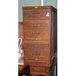 AN OLD OAK THREE-DRAWER FILING CABINET