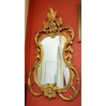 AN ATTRACTIVE CARTOUCHE-SHAPED PAINTED AND PARCEL GILT WALL MIRROR