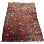 A SMALL RED GROUND BOKHARA RUG