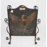 AN ARTS AND CRAFTS EMBOSSED AND WROUGHT IRON FIRE SCREEN