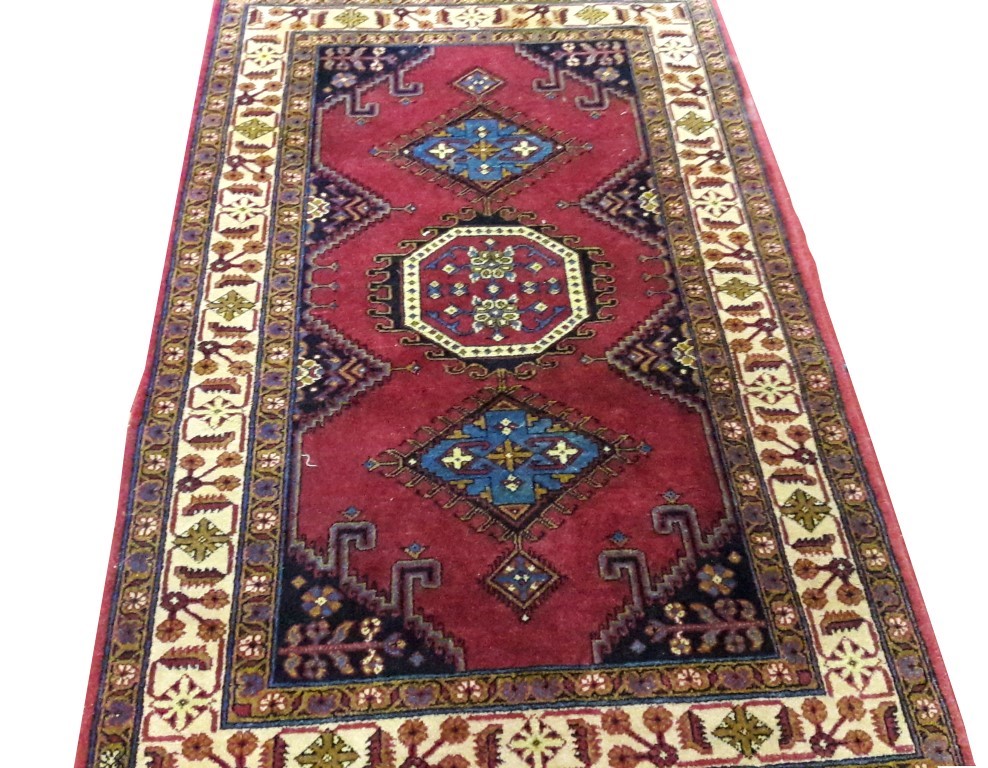 AN ORIENTAL RUG