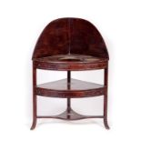 AN IRISH GEORGE IV PERIOD MAHOGANY BOW FRONTED CORNER WASH STAND