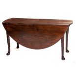 AN EIGHTEENTH CENTURY CARVED WALNUT DROP-LEAF DINING TABLE