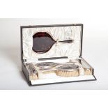 A FIVE-PIECE SILVER-MOUNTED TORTOISE SHELL GROOMING SET