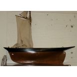 A LARGE BROWN BLACK AND CREAM PAINTED WOODEN POND YACHT,