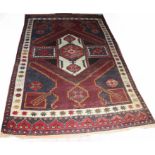 A MULTI-COLOURED ORIENTAL RUG