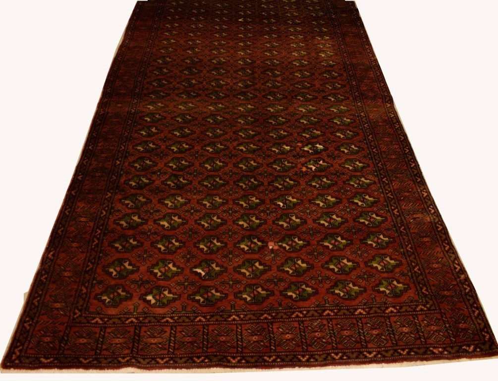 A DARK RED GROUND PERSIAN RUG