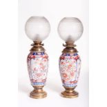 A PAIR OF JAPANESE IMARI PORCELAIN VASE SHAPED OIL LAMPS,