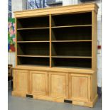 A VICTORIAN STRIPPED ASH BOOKCASE THE LOWER PART WITH PANELLED DOORS, 248CM X 238CM