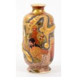 A JAPANESE SATSUMA EARTHENWARE VASE MOULDED WITH A DRAGON AND PAINTED WITH RAKAN, 17CM H, PAINTED