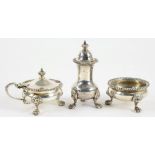 A SILVER COMPOSED THREE PIECE GADROONED CONDIMENT SET ON LION MASK FEET PEPPER CASTER 9.5CM H