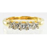 A DIAMOND FIVE STONE RING WITH PRINCESS CUT DIAMONDS IN GOLD MARKED 750, 3.8G