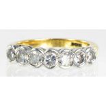 A DIAMOND SEVEN STONE RING IN 18CT GOLD, 5.6G