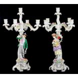 A PAIR OF GERMAN FLORAL ENCRUSTED CANDELABRA OF FIVE LIGHTS, THE BASE WITH FIGURES OF FRUIT AND