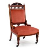 AN EARLY 20TH CENTURY CARVED MAHOGANY NURSING CHAIR