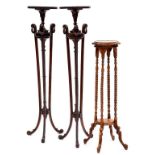 A PAIR OF NEO CLASSICAL STYLE MAHOGANY TORCHERES, 135XM H AND ANOTHER
